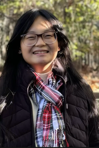 Evelina Cheng standing in front of trees
