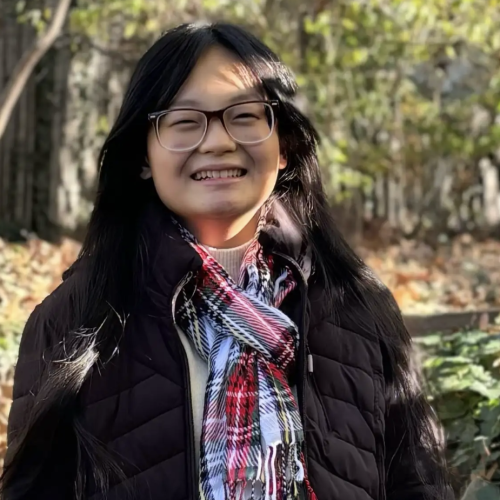 Evelina Cheng standing in front of trees