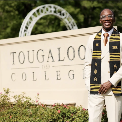 Wykendrick Jones standing next to Toogaloo College entrance